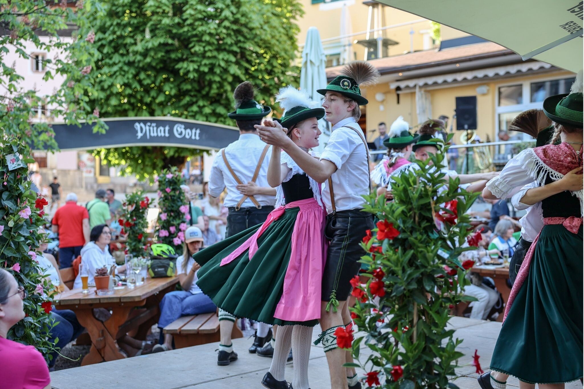 Traditional Bavarian folk dancers performing in the beer garden at Gasthof NEUHAUS Berchtesgaden